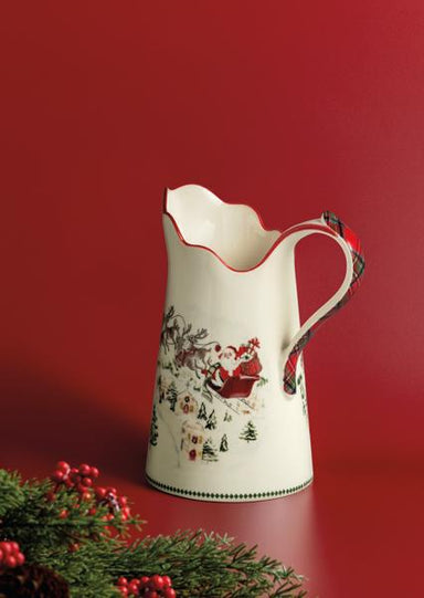 Decorative ceramic pitcher with Christmas design on a red background