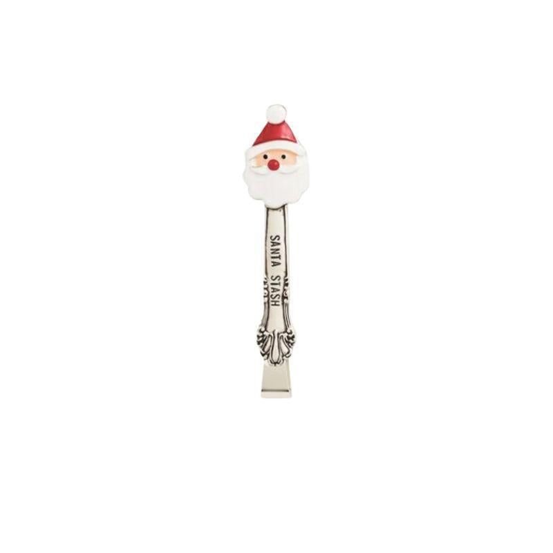 Spoon-shaped Santa Claus figurine on a white background