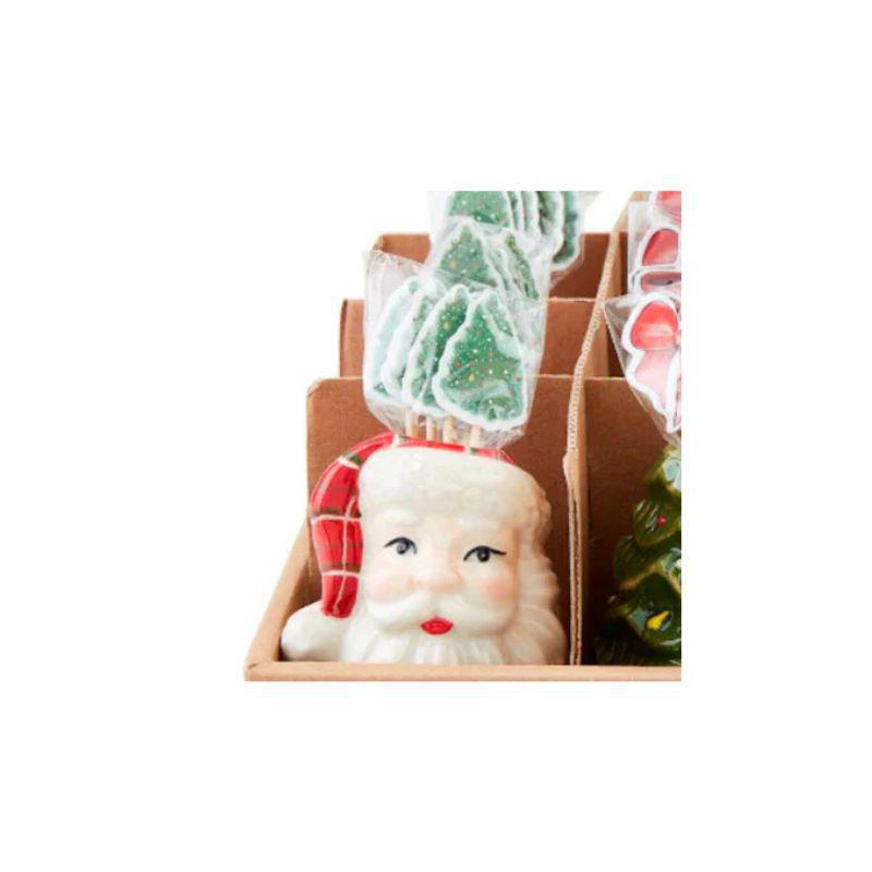 Decorative item with a Santa Claus face and candy cane hat on a white background