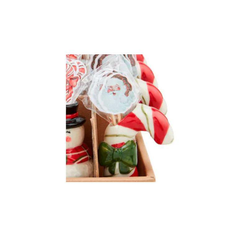 Decorative candy canes with Santa Claus design in a wooden box on a white background