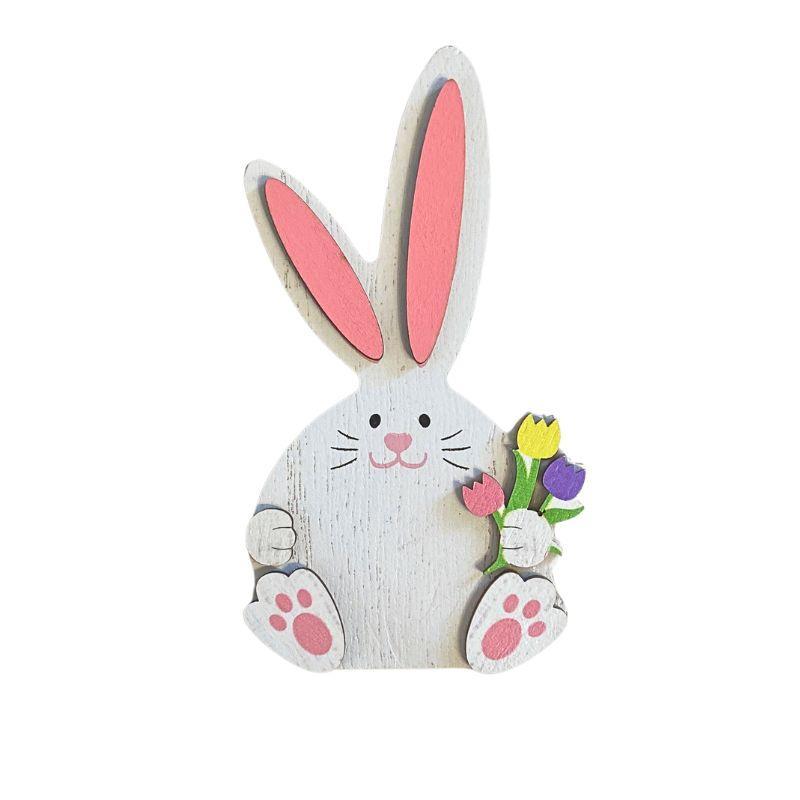 Decorative rabbit figure with pink ears and a flower bouquet on a white background