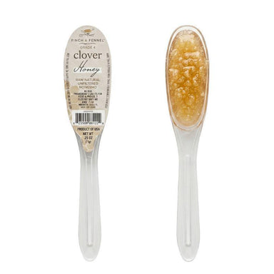 Clover honey spoon with a label on a white background