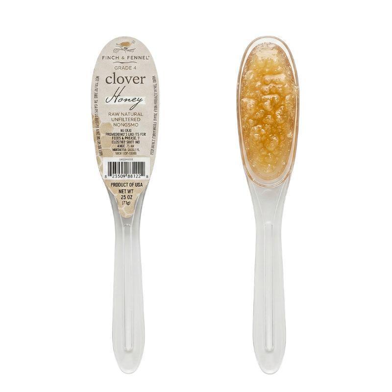 Clover honey spoon with a label on a white background