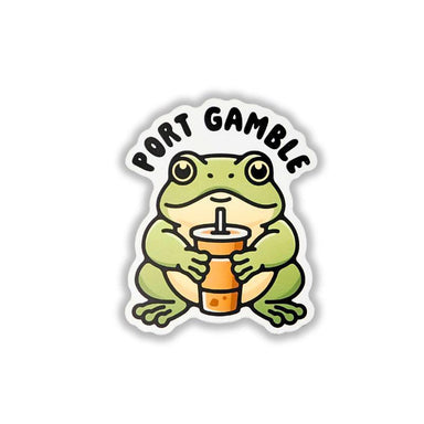 A die-cut sticker featuring a cartoon green frog holding an orange drink cup, with the text 'PORT GAMBLE' arched above it, shown on a plain white background.