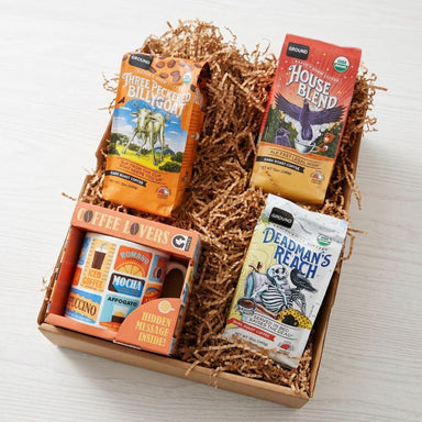 Box of coffee packages with various flavors on a white background
