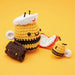 Two crochet bee toys on a yellow background