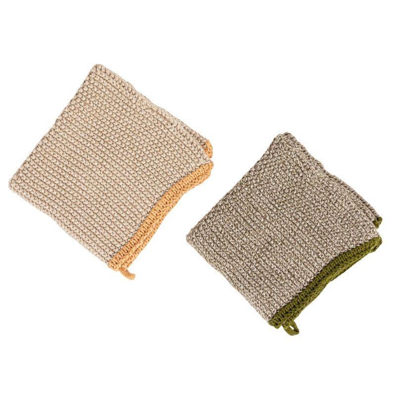 Two textured cleaning pads in beige and green on a white background