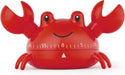 A red crab-shaped kitchen timer with a smiling face and measurement markings on the front, shown on a plain white background.