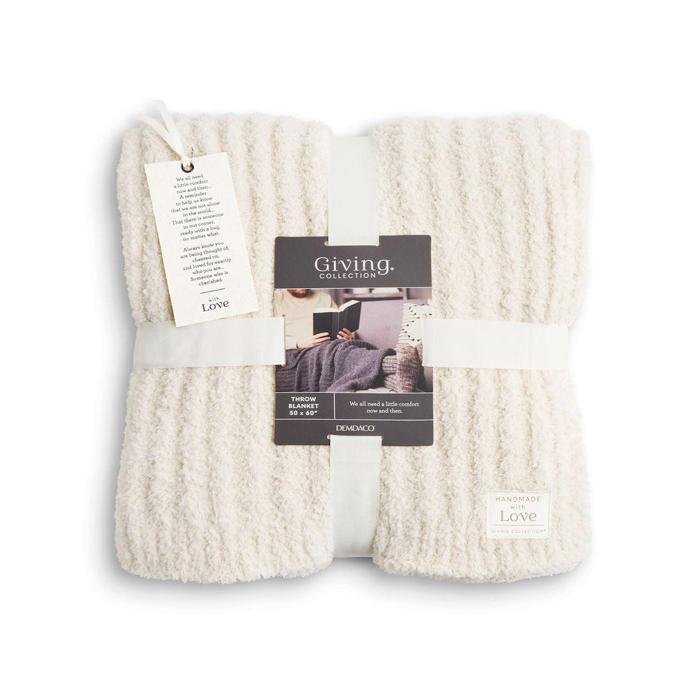 White textured blanket with a tag on a white background