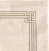Close-up of a textured fabric with geometric embroidery on a beige background