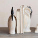 Decorative bookends shaped like birds on a wooden surface with a neutral background
