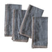 Set of four denim-colored napkins with lace trim on a white background