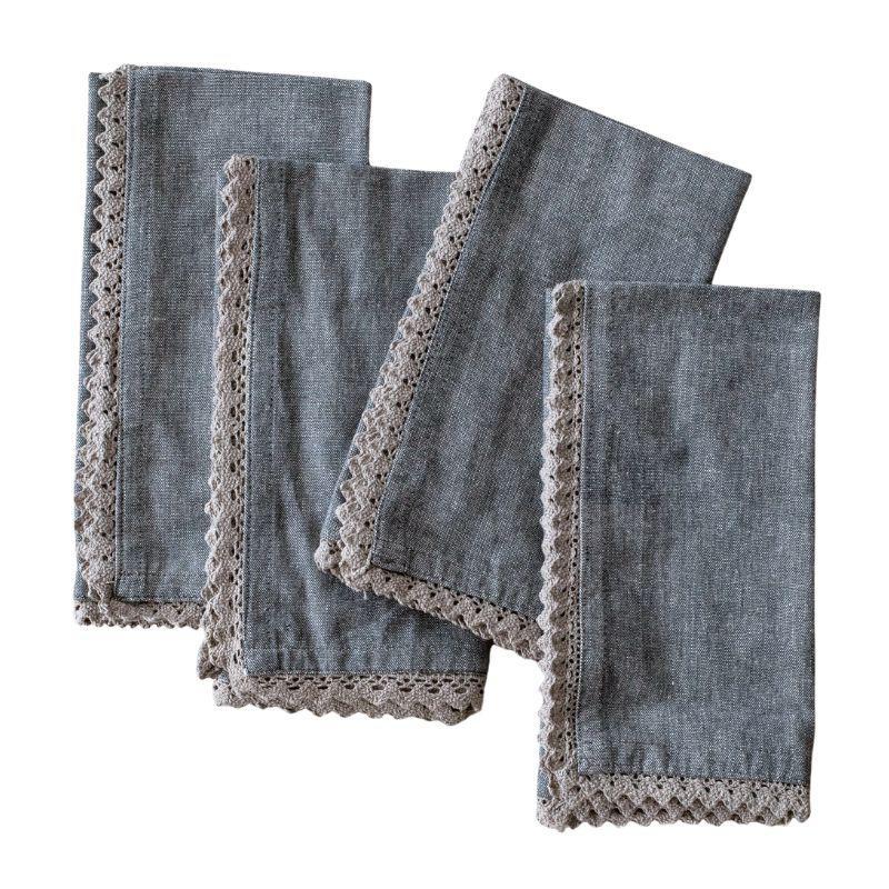 Set of four denim-colored napkins with lace trim on a white background