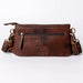 Brown leather handbag with gold accents on a white background
