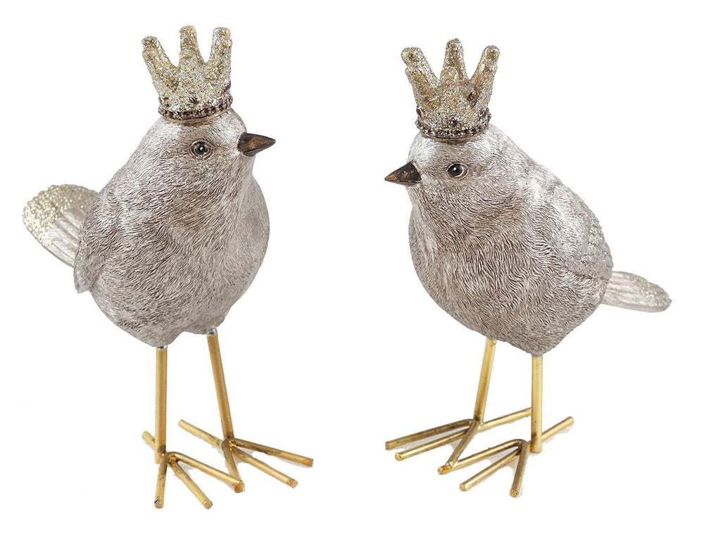 Two decorative birds with crowns on gold stands against a white background