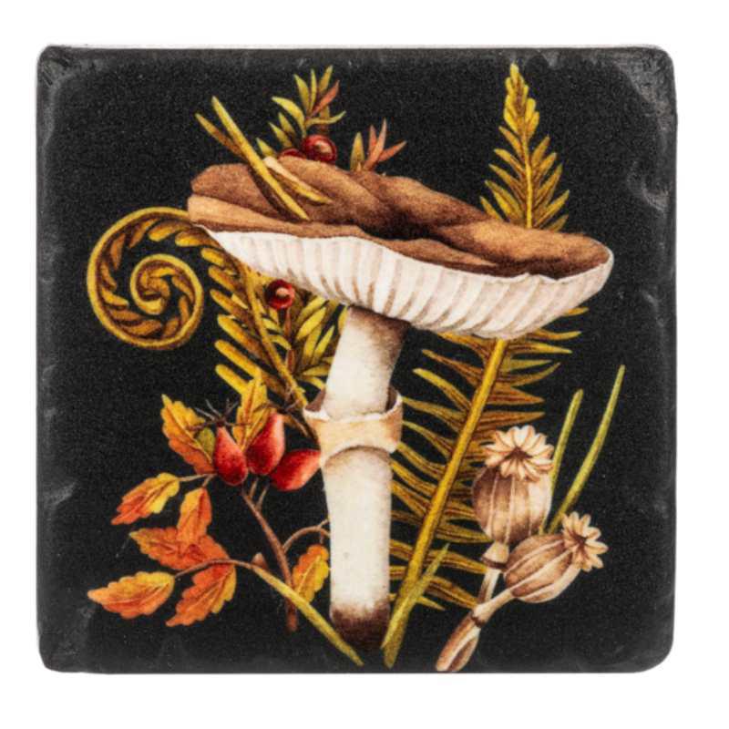 Decorative coaster with a mushroom and leaf design on a black background