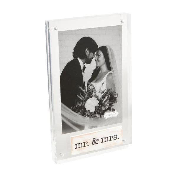 Decorative photo frame with 'mr. & mrs.' text, holding a black and white photo of a couple.