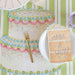 Decorative table setting with a cake-shaped napkin, fork, and 'Make a Wish!' card on a striped background.