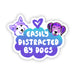 A die-cut sticker featuring cartoon dog heads and the phrase 'EASILY DISTRACTED BY DOGS' on a white background.