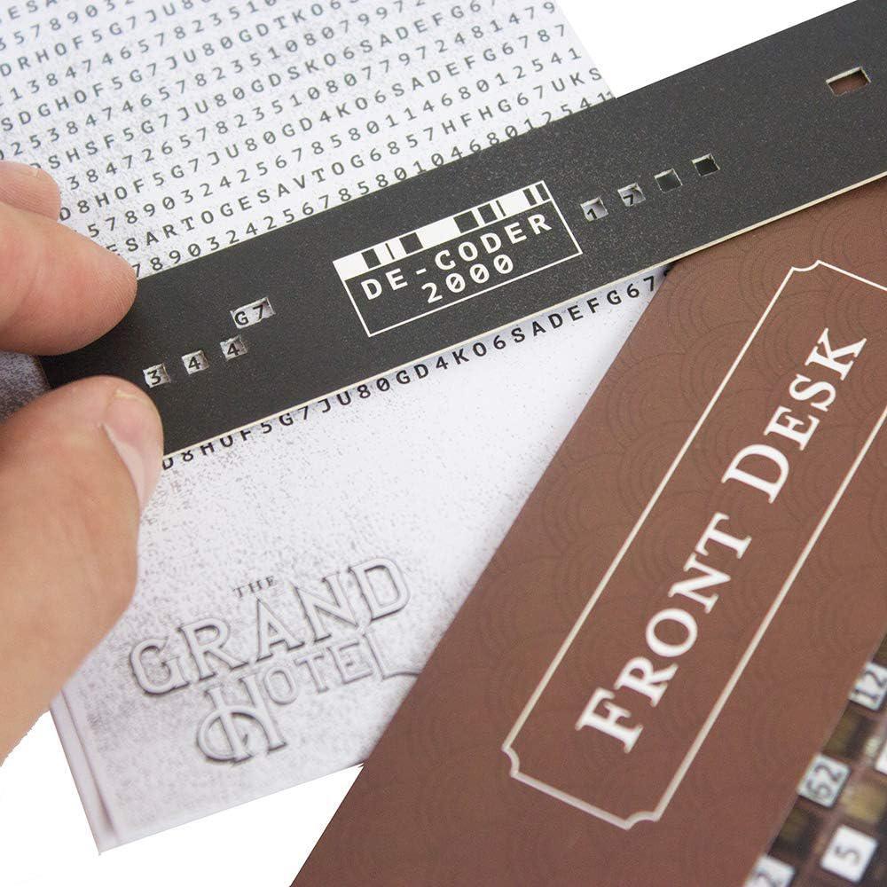 Close-up of a hand holding a decoder strip with text over a 'Grand Hotel' sign.