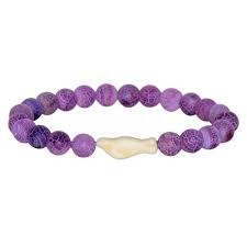 A purple beaded bracelet made of round purple gemstone beads with a central cream-colored bone or shell accent, shown on a plain white background.