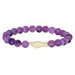 A purple beaded bracelet made of round purple gemstone beads with a central cream-colored bone or shell accent, shown on a plain white background.