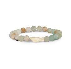 A beaded stretch bracelet made of smooth, polished natural stones in muted earthy tones of beige, brown, and light green, featuring a central irregular white stone accent, shown on a plain white background.
