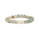 A beaded stretch bracelet made of smooth, polished natural stones in muted earthy tones of beige, brown, and light green, featuring a central irregular white stone accent, shown on a plain white background.