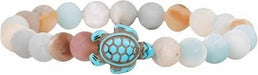 A beaded stretch bracelet featuring a central turquoise-colored turtle charm with a silver-toned patterned shell, surrounded by smooth round beads in pastel shades of blue, pink, beige, and white.