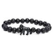 Black beaded bracelet with a gorilla charm on a white background