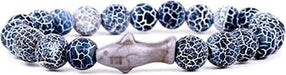 A beaded bracelet featuring dark blue and white crackled stone beads with a central gray fish-shaped bead, shown on a plain white background.