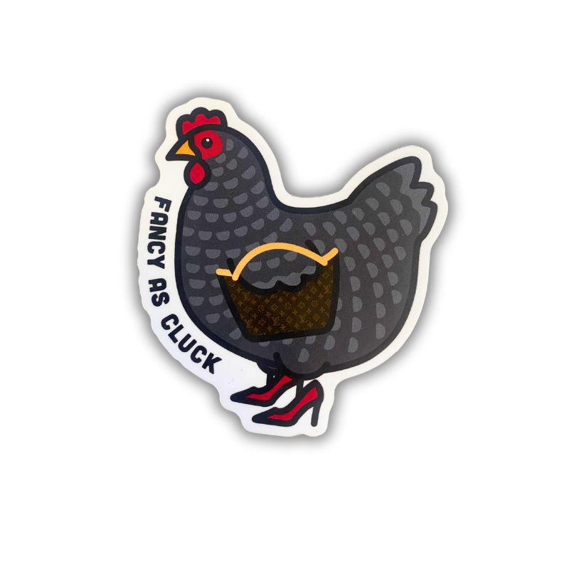 A die-cut sticker featuring a stylized dark gray speckled hen wearing red high heels and carrying a brown basket, with the text 'FANCY AS CLUCK' printed along the left side, shown on a plain white background.