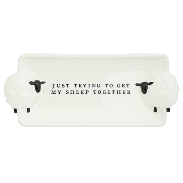 White sheep-shaped dish with black text on a white background