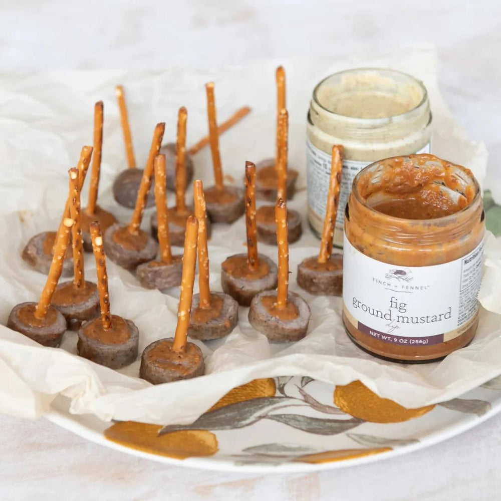  pretzel sticks with fig ground mustard on a decorative plate