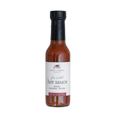 Bottle of hot sauce with a label on a white background
