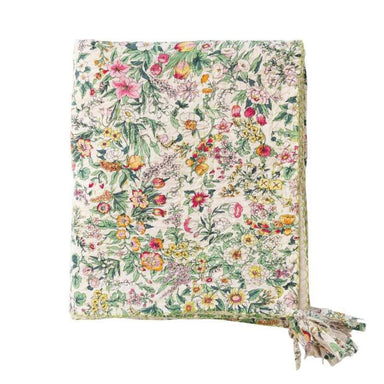 Floral patterned blanket with tassels on a white background