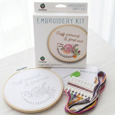 Embroidery kit with hoop, thread, and packaging on a white background