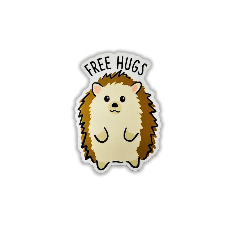 A die-cut sticker featuring a cute cartoon hedgehog with the words 'FREE HUGS' above it, shown on a plain white background.