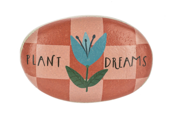 Decorative stone with a checkered pattern, blue flower, and green leaves on a white background.