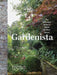 Book cover of 'Gardenista' with a garden scene and stone wall.