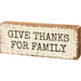 Wooden block sign with 'Give Thanks for Family' text on a white background