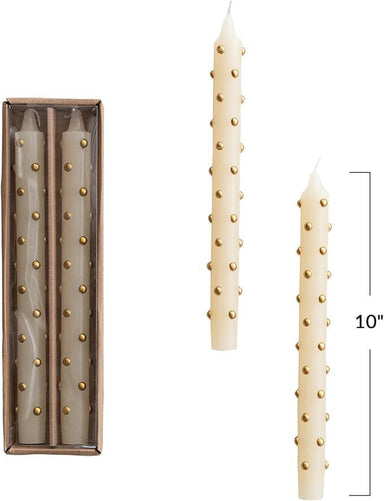 Set of decorative candles with gold studs, one candle standing tall and the other in packaging.