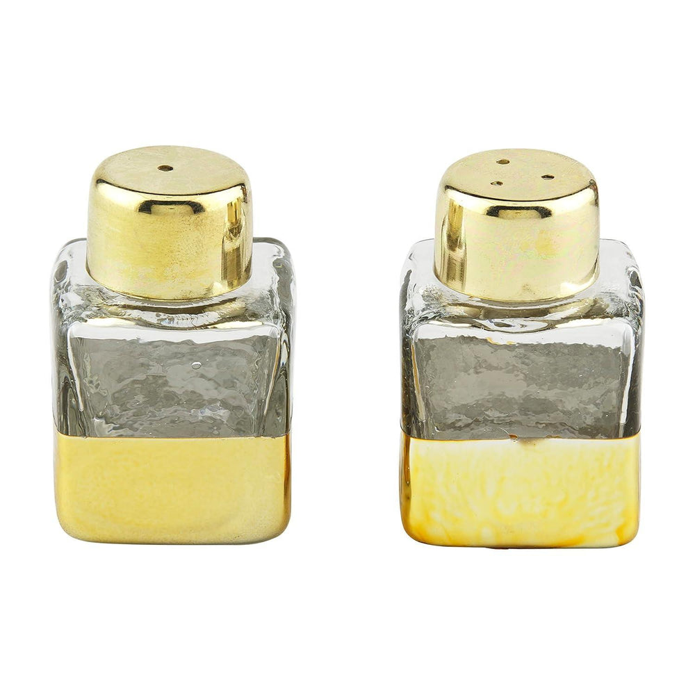 Two glass salt and pepper shakers with gold bases and tops on a white background