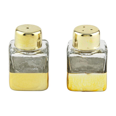 Two glass salt and pepper shakers with gold bases and tops on a white background