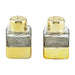 Two glass salt and pepper shakers with gold bases and tops on a white background