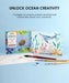 Watercolor coloring book with ocean-themed illustrations on a blue background, featuring a turtle, dolphin, and starfish.