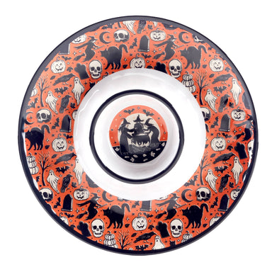 A round Halloween-themed melamine plate with a white center and a vibrant orange rim decorated with black and white spooky illustrations including skulls, cats, ghosts, pumpkins, and a haunted house.