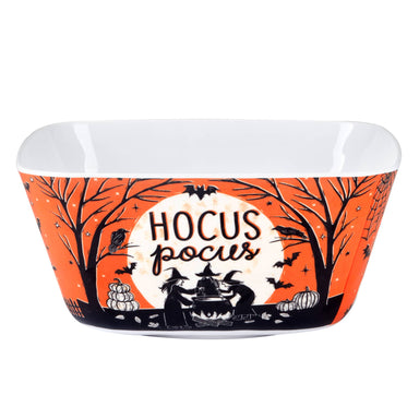 A Halloween-themed melamine bowl with a white interior and a printed exterior featuring an orange background, black silhouettes of trees and witches around a cauldron, bats, pumpkins, and the words 'HOCUS POCUS' on a white circle.
