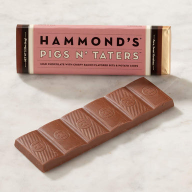 Chocolate bar with 'Hammond's Pigs N' Taters' packaging on a light background