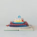 Colorful butter dish with floral pattern on a stack of books against a white background